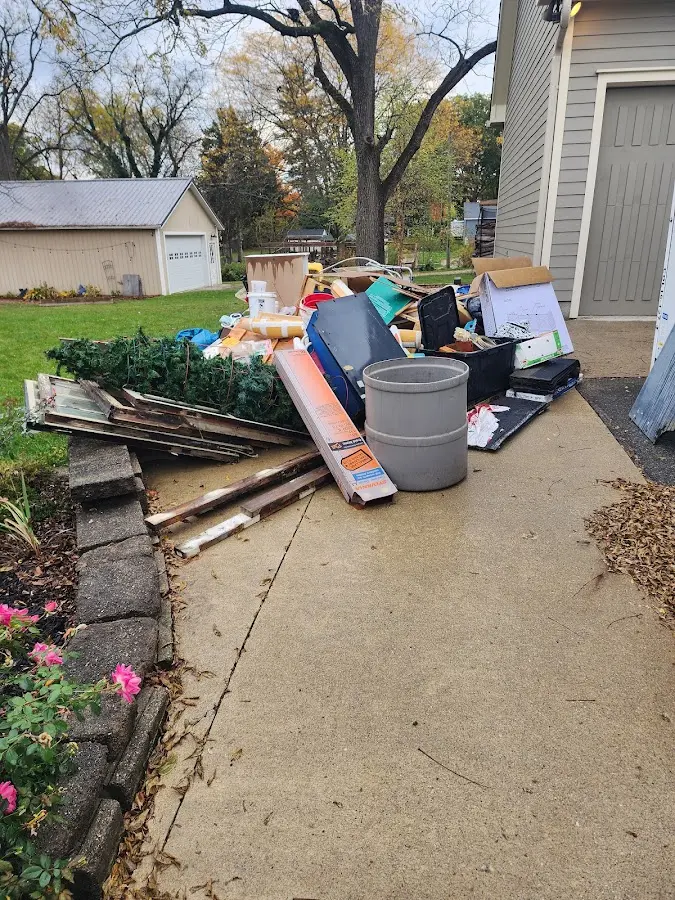 Dumpster being loaded with debris for 10 Yard Dumpster Rental in La Junta